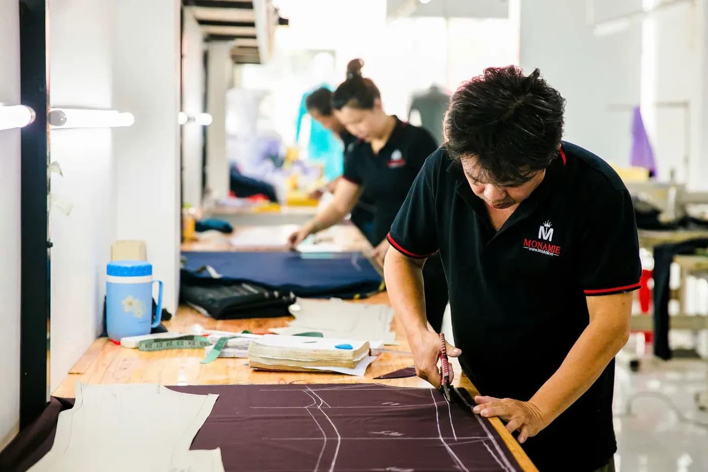 Cắt vải vest tím than trên bàn cắt