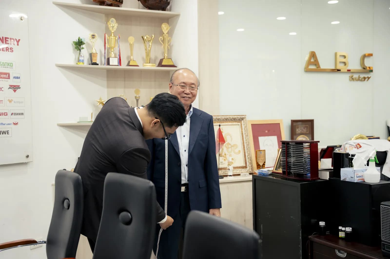 Chuyên viên Mon Amie lấy số đo cho doanh nhân Kao Siêu Lực tại văn phòng