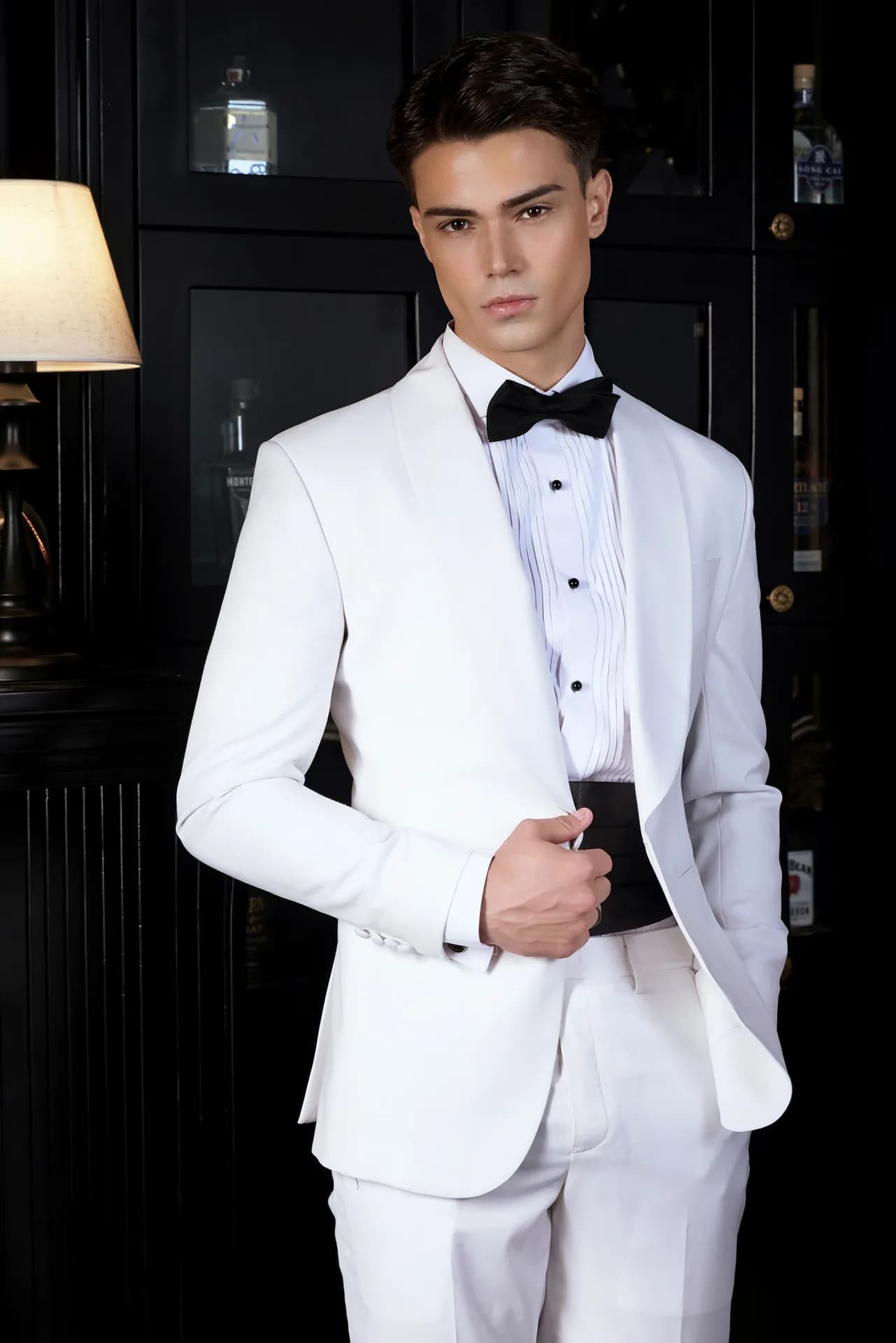 Tuxedo trắng cổ shawl, nơ đen, đai bụng đen, ánh nhìn trực diện
