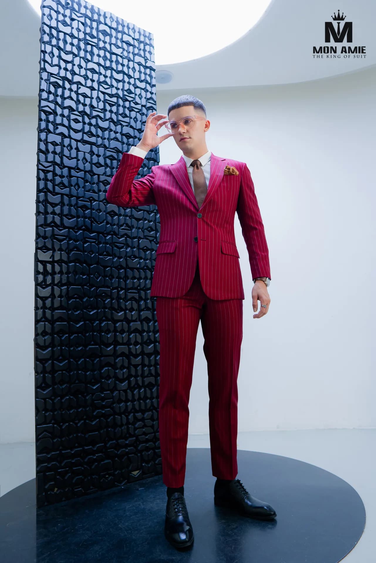 Tuxedo trắng cổ ve lụa đen bên quầy bar gỗ tối màu
