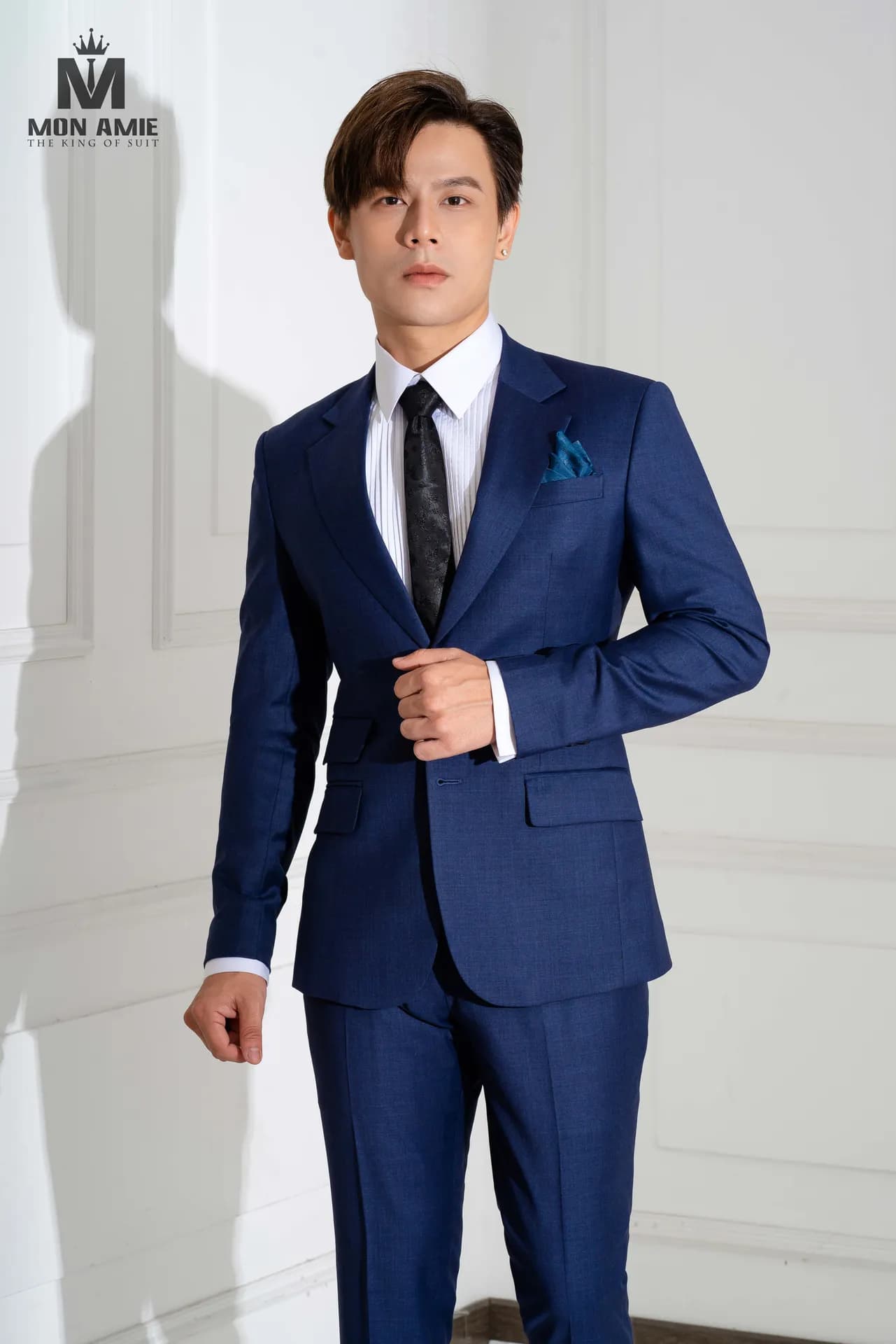 Suit xanh navy cận cảnh, cà vạt đen, khăn cài túi xanh