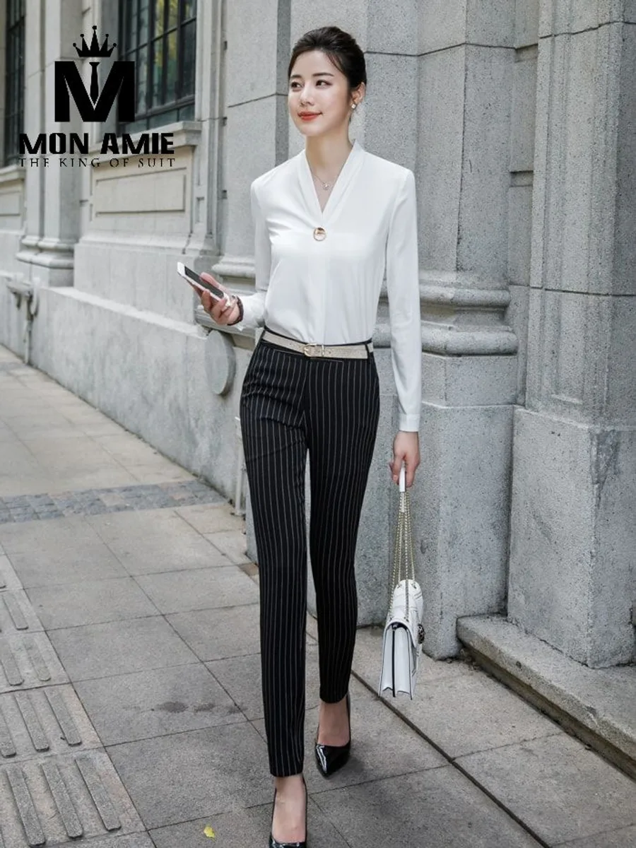 White V-Neck Blouse with Gold Button and Pinstripe Trousers