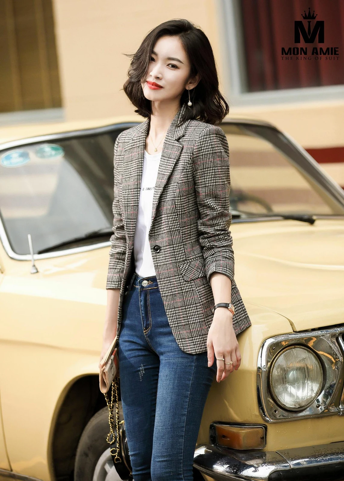 A grey glen-check women's blazer with pink threads, an example of wool blend for a structured office women's suit