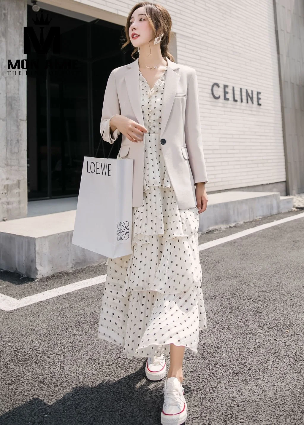 Cream-beige single-button women's blazer in a straight cut with rolled sleeves, an example of a neat straight-cut women's blazer silhouette