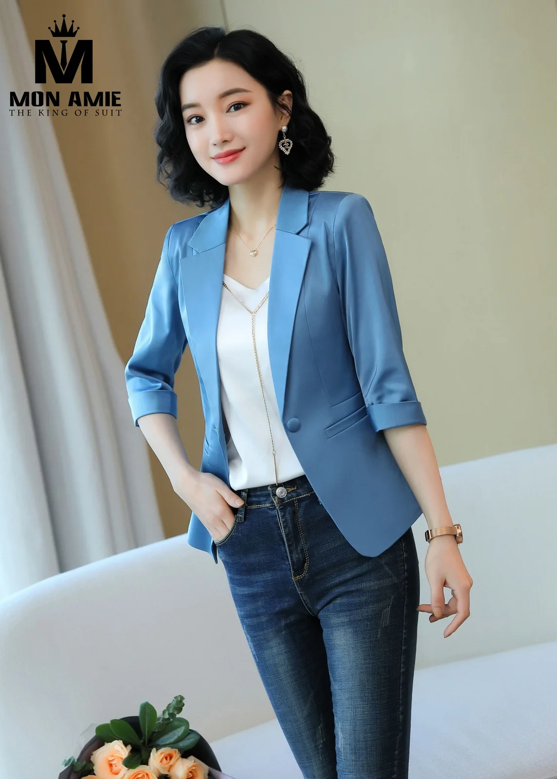 A blue satin-sheen women's blazer with three-quarter sleeves, an example of silk blend and satin cloth for an event women's suit