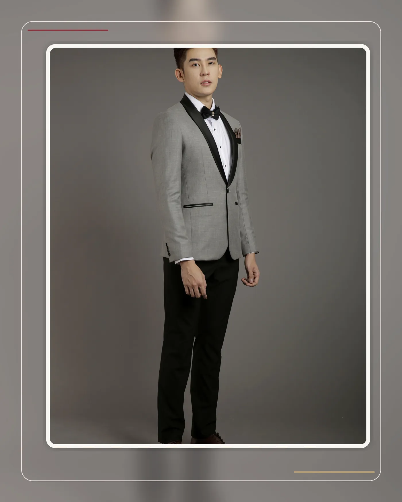 Groom in a formal grey tuxedo suited to a hotel ballroom wedding reception