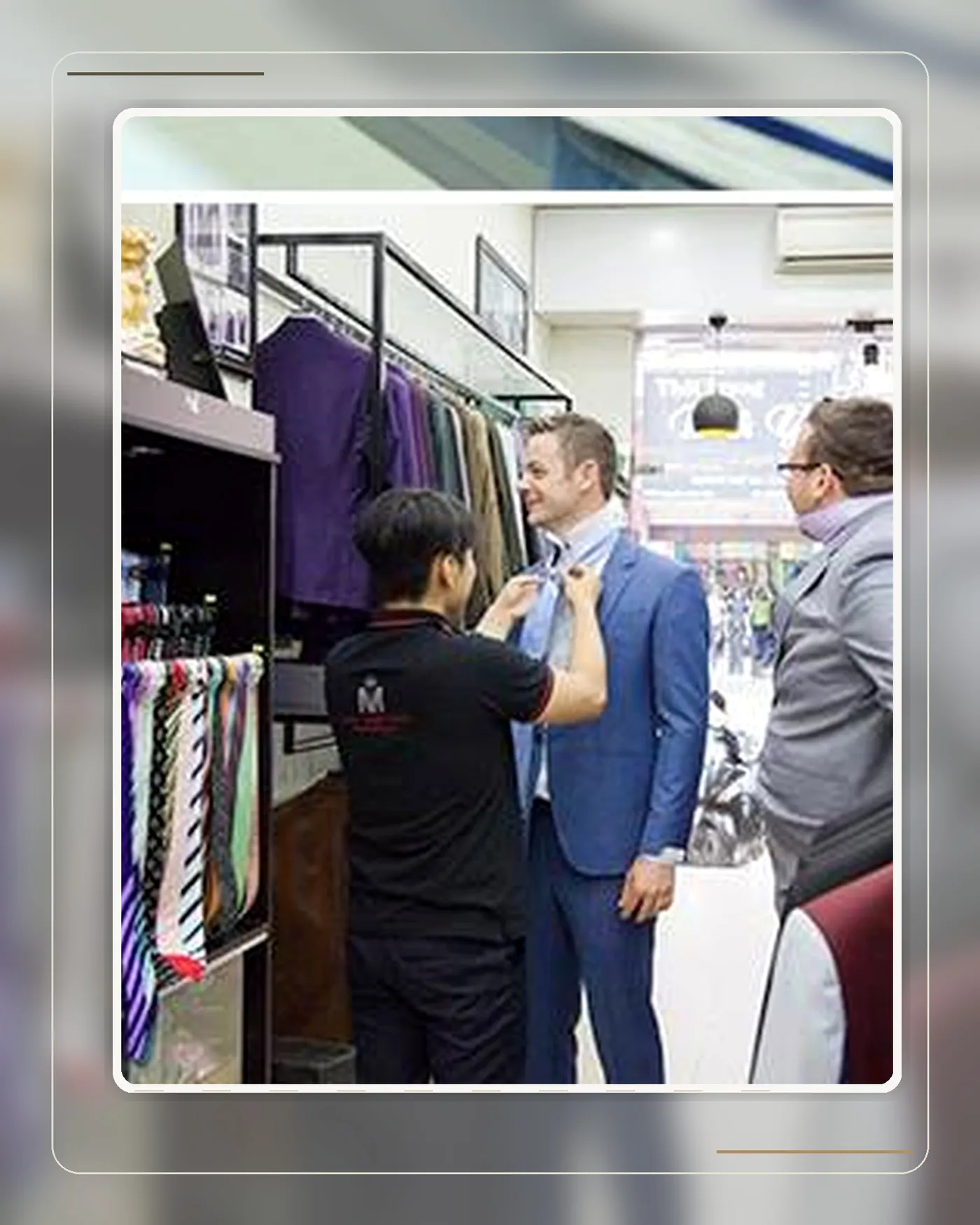 A client checking the fit of a finished jacket at a Mon Amie store