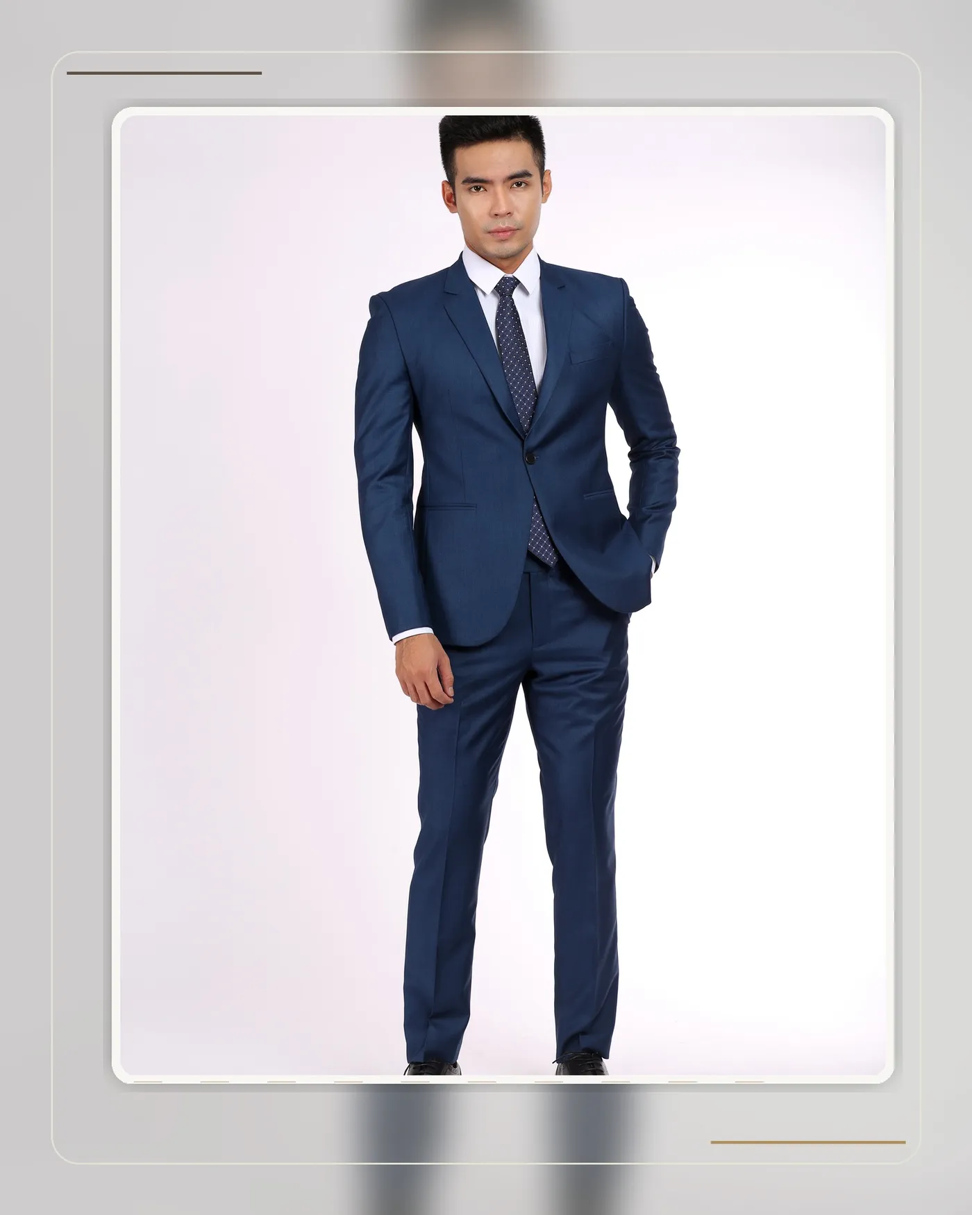A well-fitted navy suit showing a clean waistline and structured shoulders