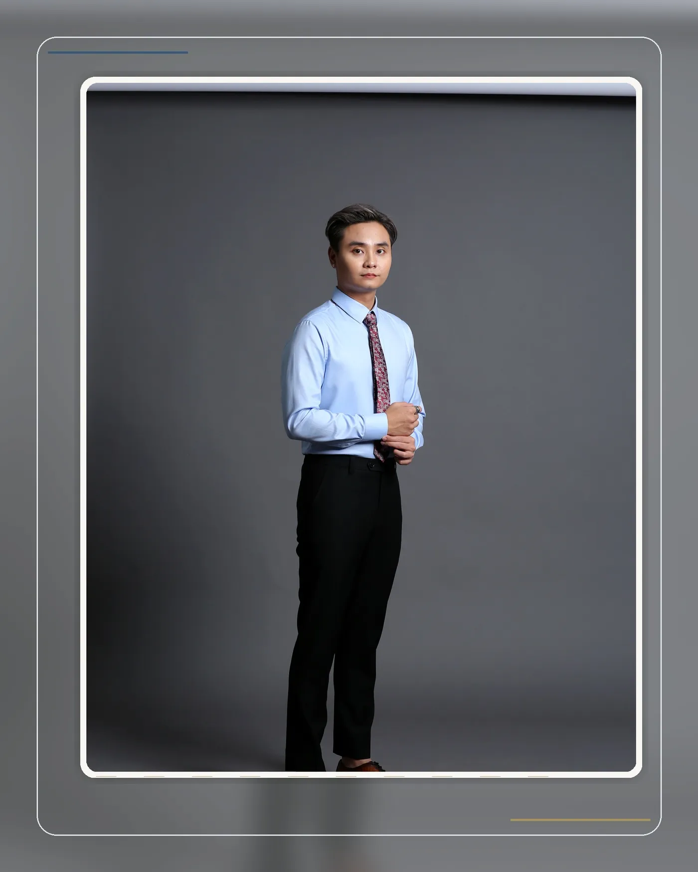 Navy patterned tie paired with a light blue shirt and striped suit