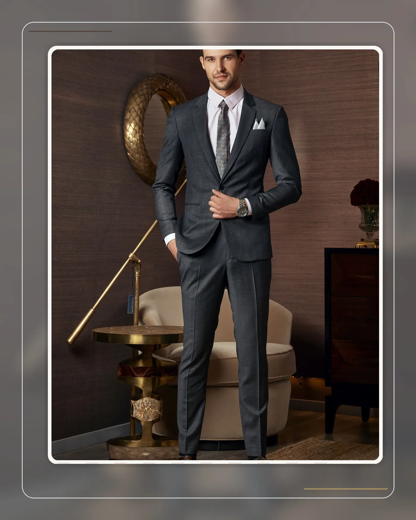 A complete charcoal suit with lapels, buttons and proportions refined in every detail