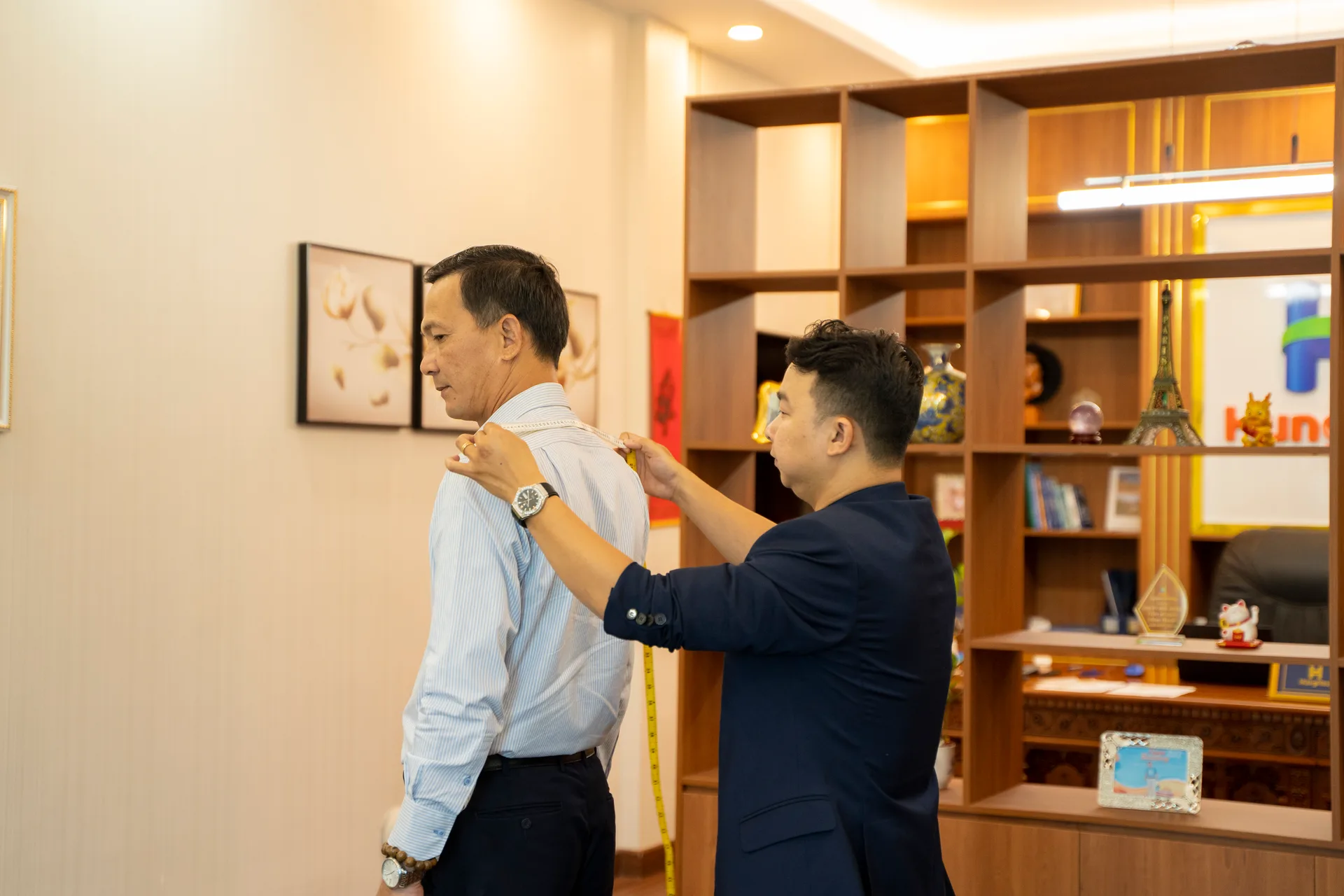 Measuring a company leader's shoulders in a formal office