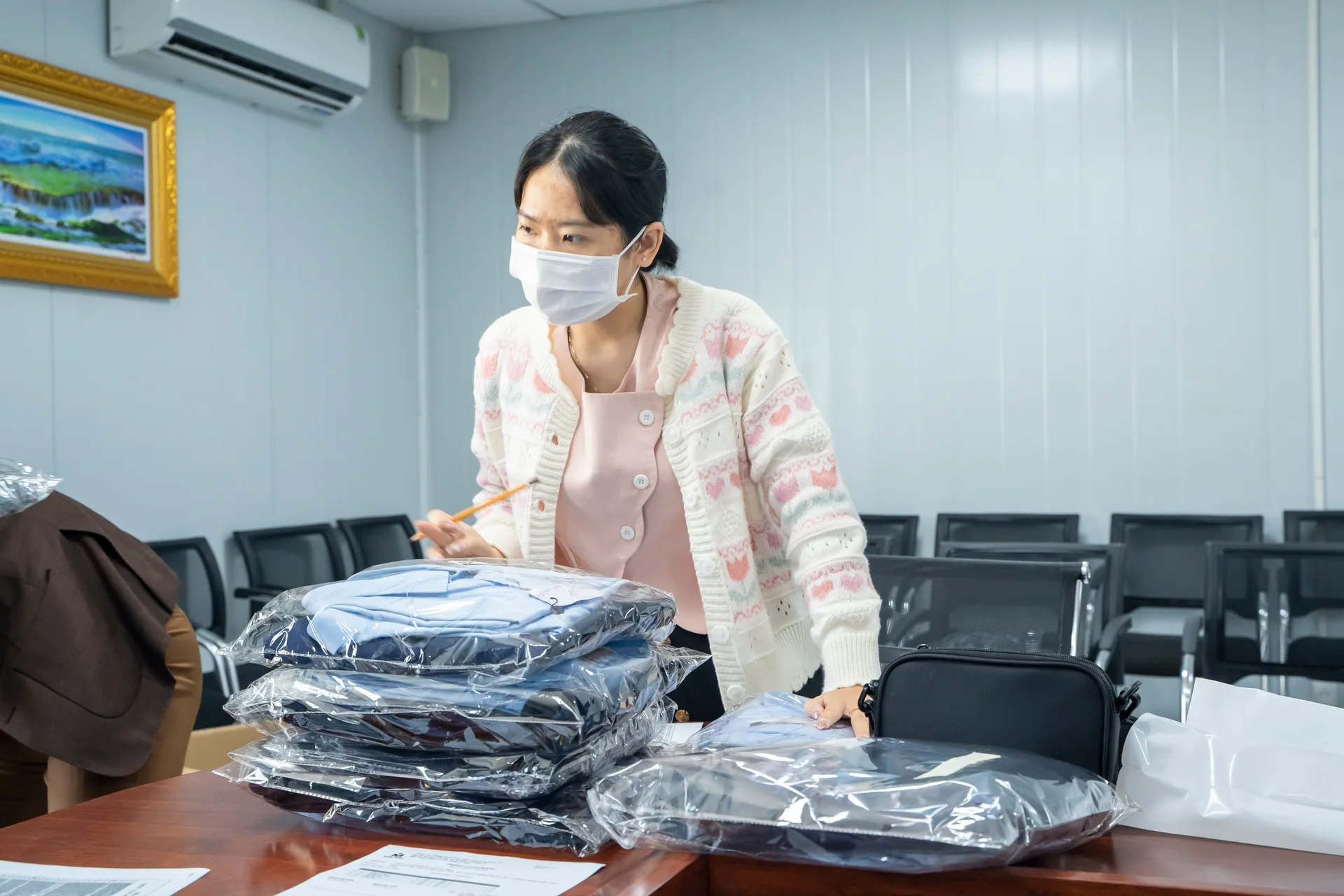 Uniforms arranged in individual bags, ready to hand out to staff