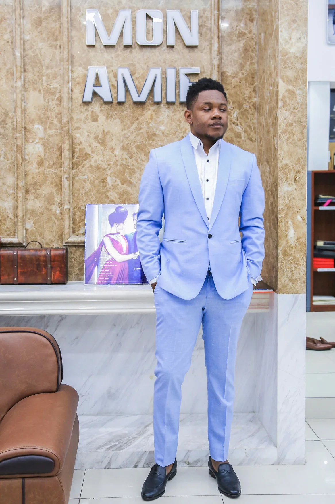 A young man in a pastel blue suit and white shirt, a palette that father and son can choose together